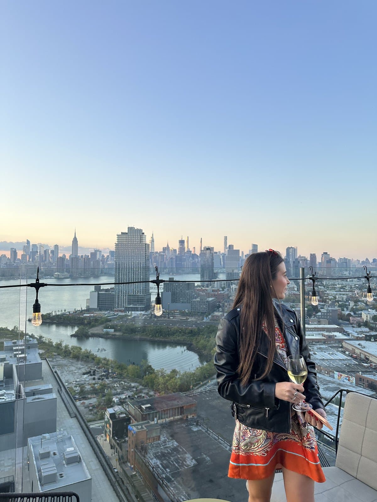 Corinne on a rooftop, facing Manhattan